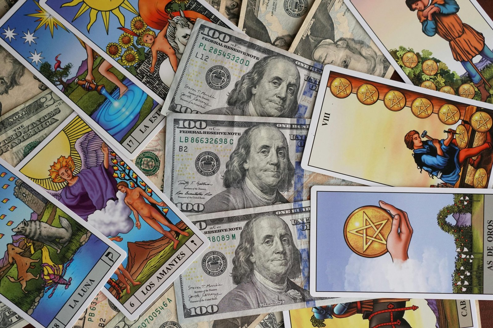 A collection of Tarot cards artfully arranged with US dollar bills, symbolizing fortune and wealth.